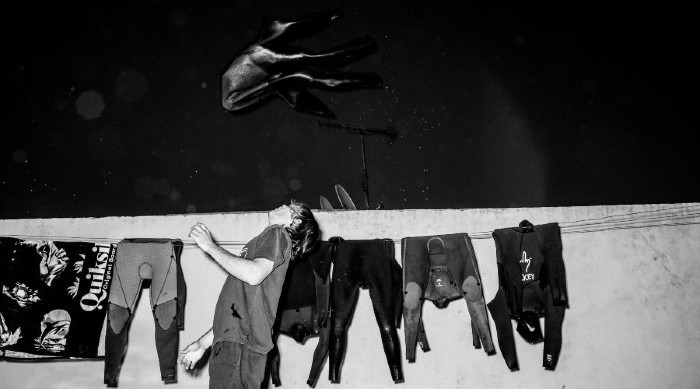 wetsuits drying on clothesline