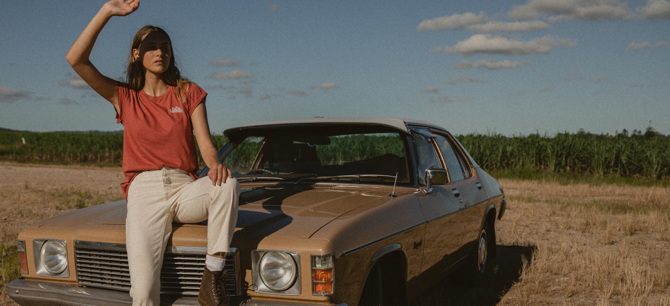 Girl leaning on car in white denim straight jeans