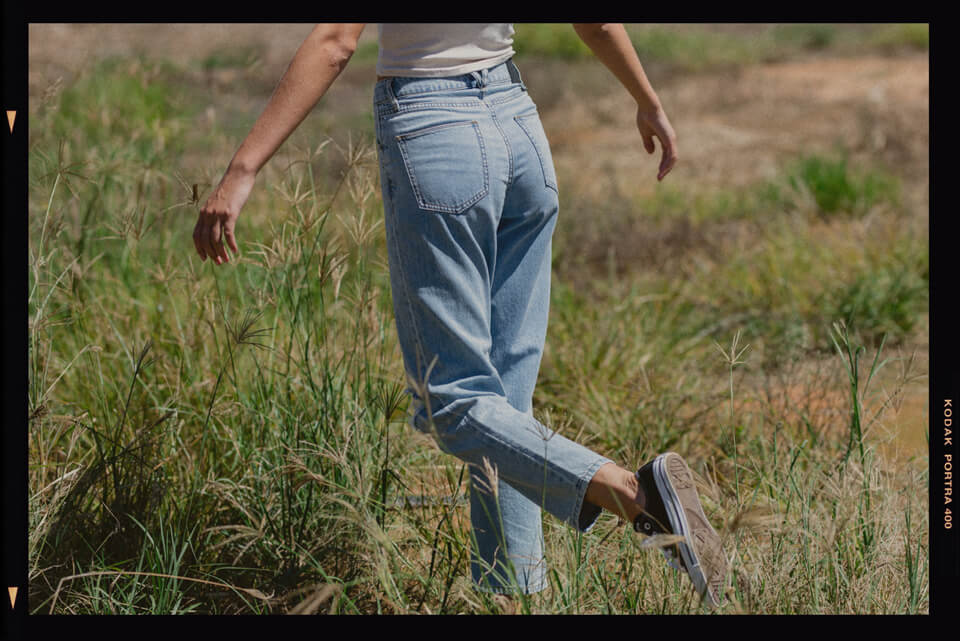 Back of thrills blue denim jeans with women spinning her arms